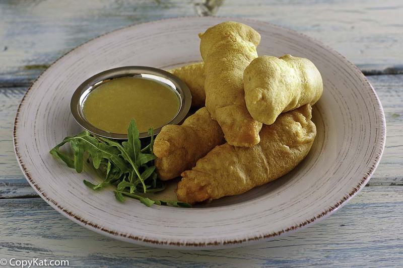 homemade Chilis Chicken Crispers and honey mustard sauce on a plate.