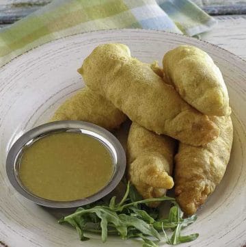 Copycat Chili's Chicken Crispers and honey mustard sauce on a white plate.