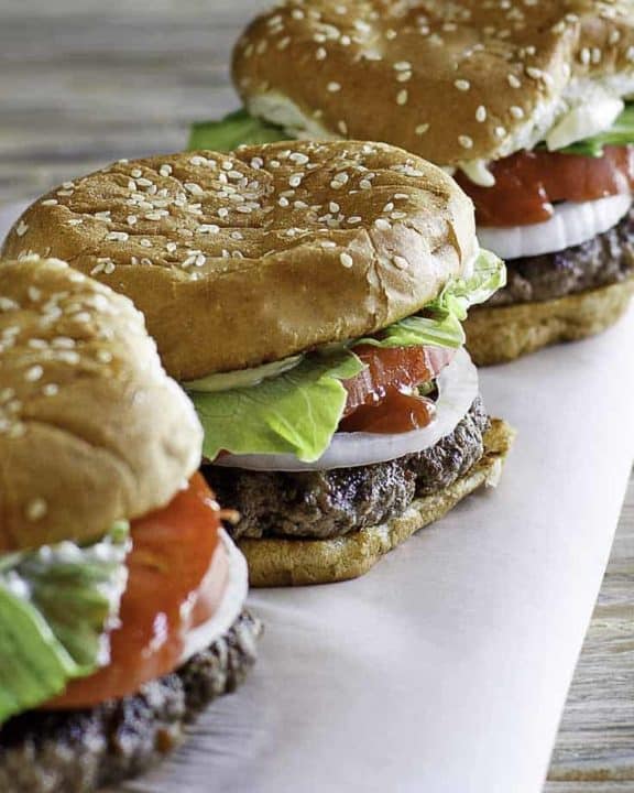 Three hamburgers on a table