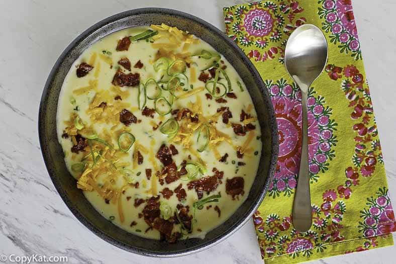 baked potato soup topped with bacon, cheese, and green onions