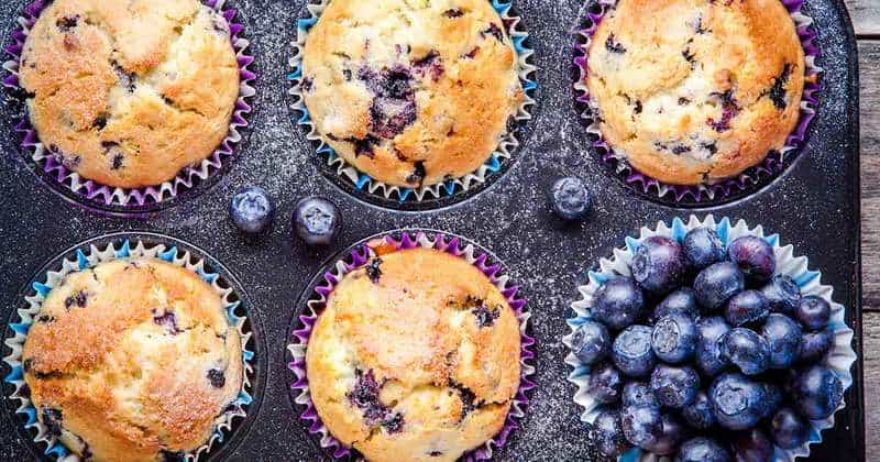 Blueberry Muffins and blueberries in a muffin tin