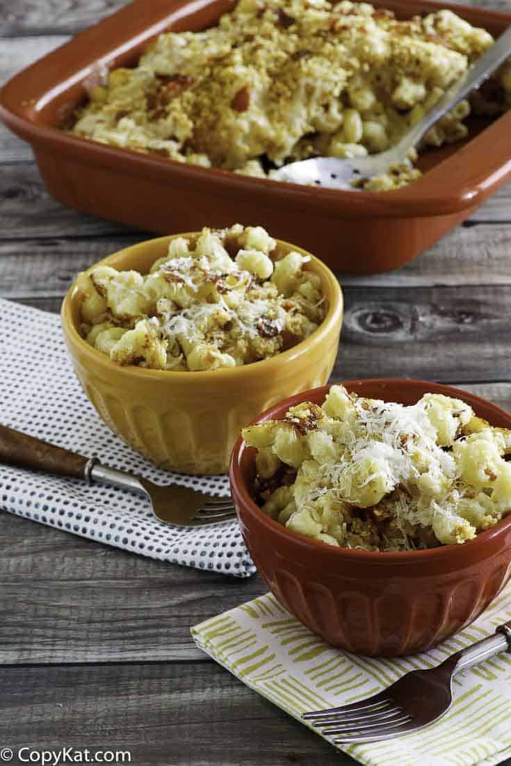 Homemade copycat Steakhouse Macaroni and Cheese in two bowls and a baking dish.