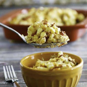 Homemade copycat Longhorn Steakhouse Macaroni and Cheese in a spoon and small orange bowl.