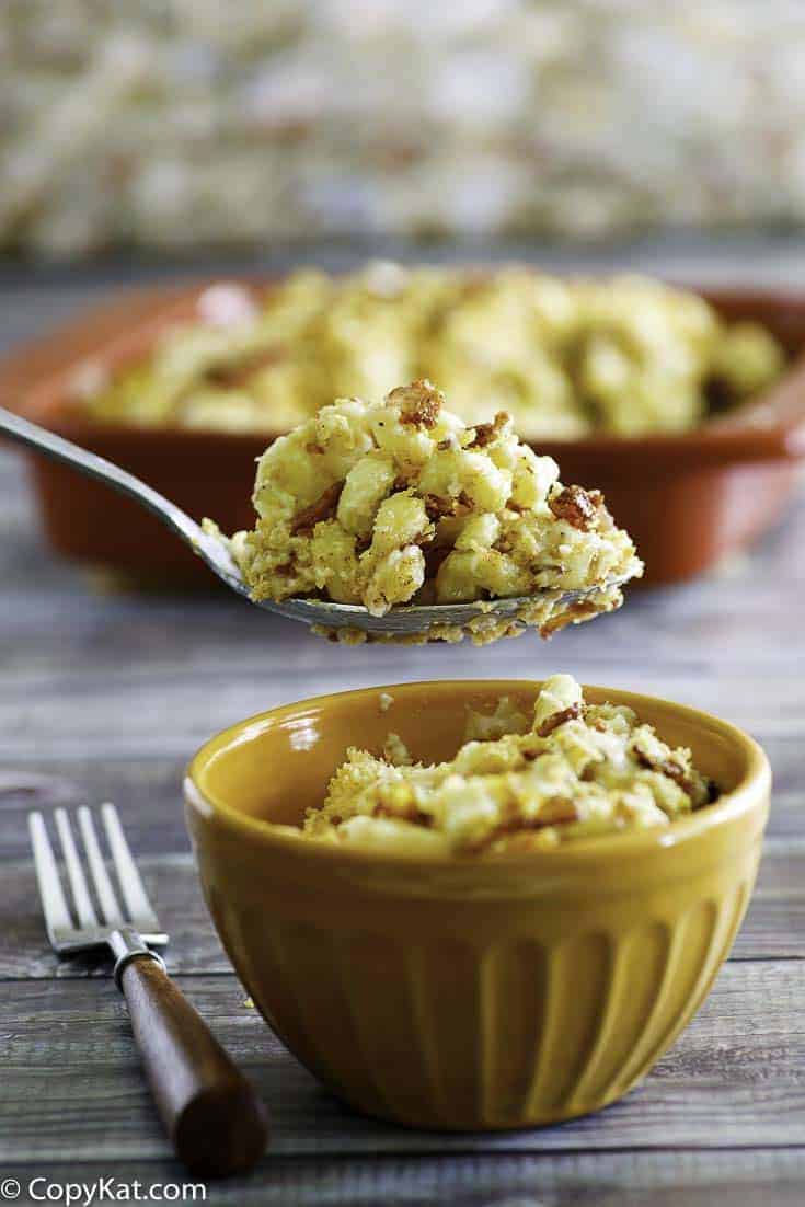 Homemade copycat Longhorn Steakhouse Macaroni and Cheese in a spoon and small bowl.
