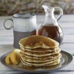 a stack of country griddle cakes with syrup