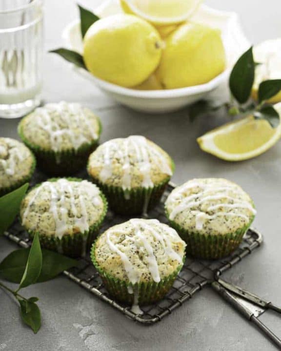 six bakery style lemon poppy seed muffins and lemons