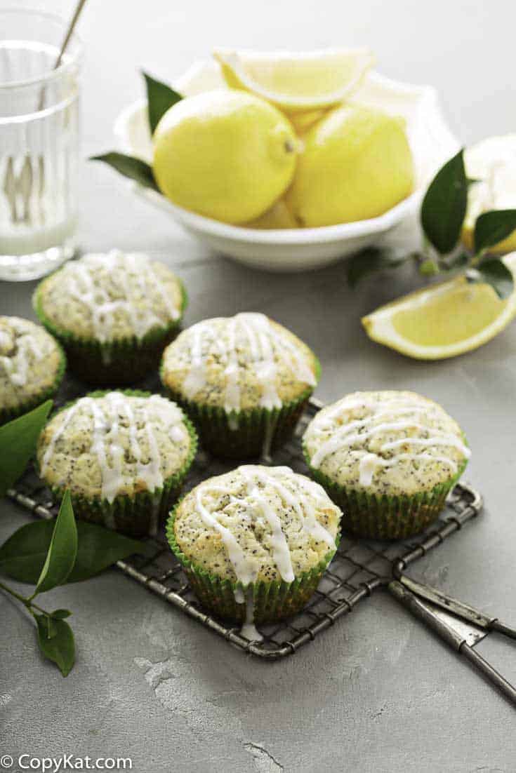 six bakery style lemon poppy seed muffins and lemons