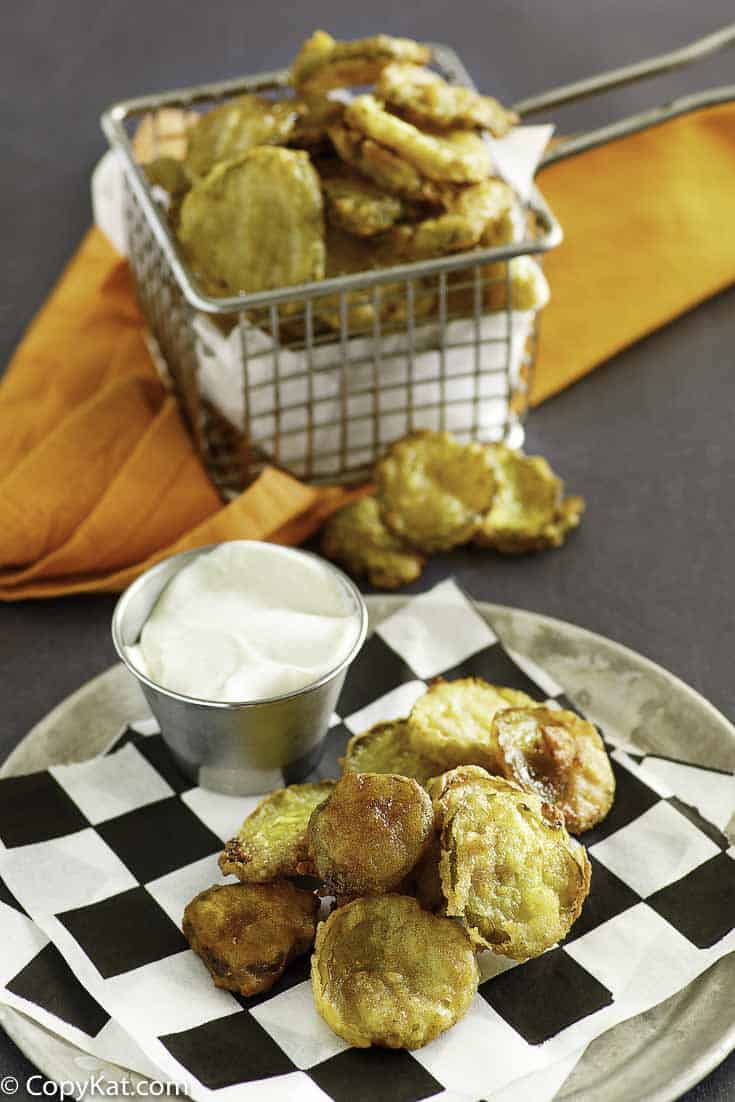 fried pickles on a plate and in a fry basket