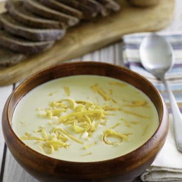 Homemade copycat Outback Walkabout Soup in a bowl in front of sliced wheat bread.