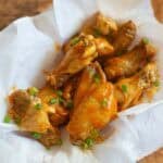 A basket of air fryer garlic buffalo chicken wings.