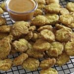 Homemade copycat Red Robin Pickle Nickels (fried pickles) and dipping sauce on a serving platter.
