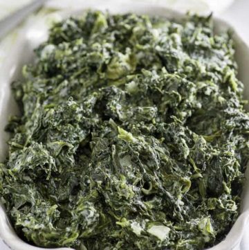 Homemade copycat Boston Market creamed spinach in a white serving dish.