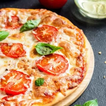 Margherita pizza on a pizza stone.