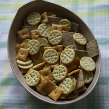 A bowl of three different types of seasoned crackers.