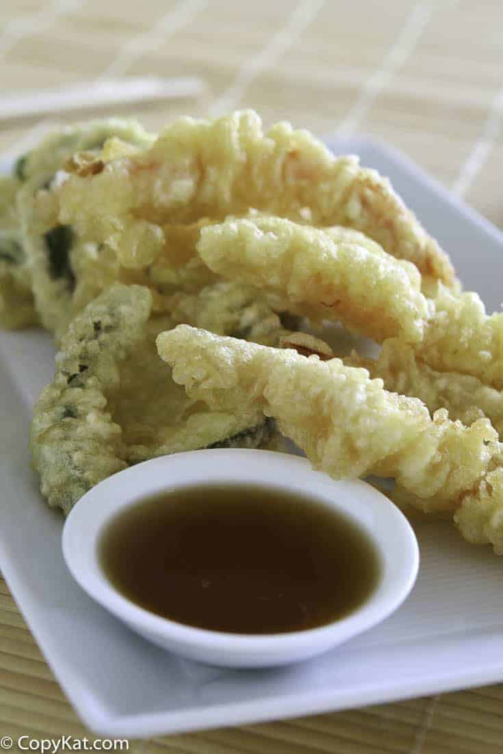 Vegetables fried in tempura batter on a plate.