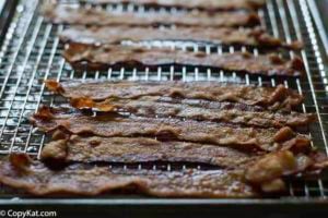 Cooked bacon on a baking sheet.