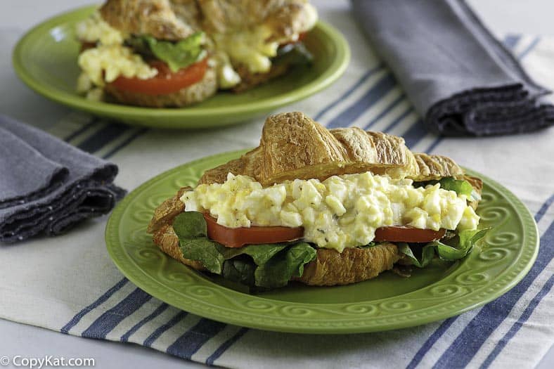 A homemade copycat Chicken Salad Chick egg salad sandwich served on a croissant. 