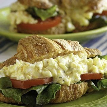 A homemade copycat Chicken Salad Chick egg salad sandwich with lettuce and tomato