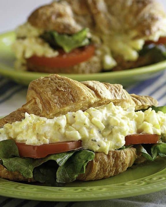 A homemade copycat Chicken Salad Chick egg salad sandwich with lettuce and tomato