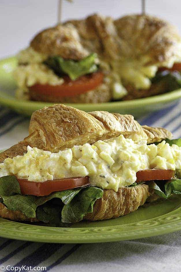 A homemade copycat Chicken Salad Chick egg salad sandwich with lettuce and tomato