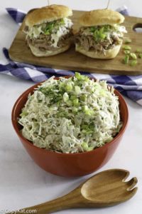 Homemade Houston's coleslaw in a bowl and on pork sandwiches