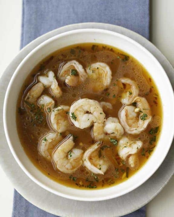 Shrimp cooked in a spicy broth in a bowl.
