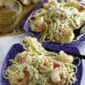 Two plates of homemade copycat Olive Garden shrimp alfredo pasta