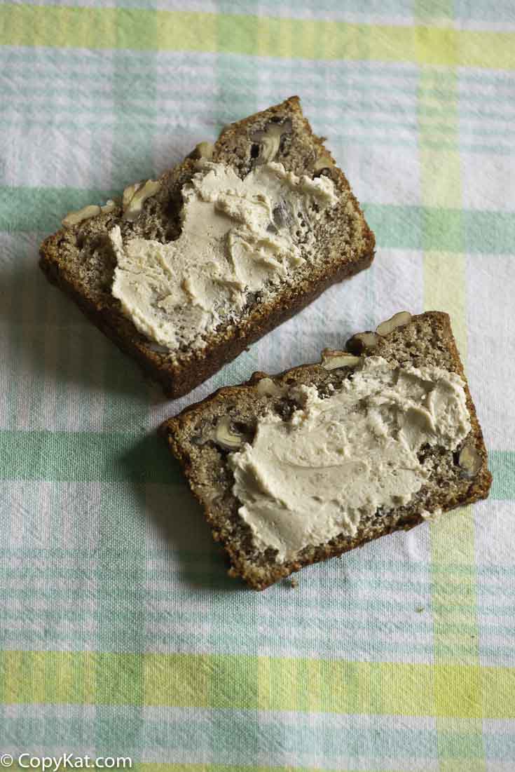 Two slides of whole wheat banana bread with butter.