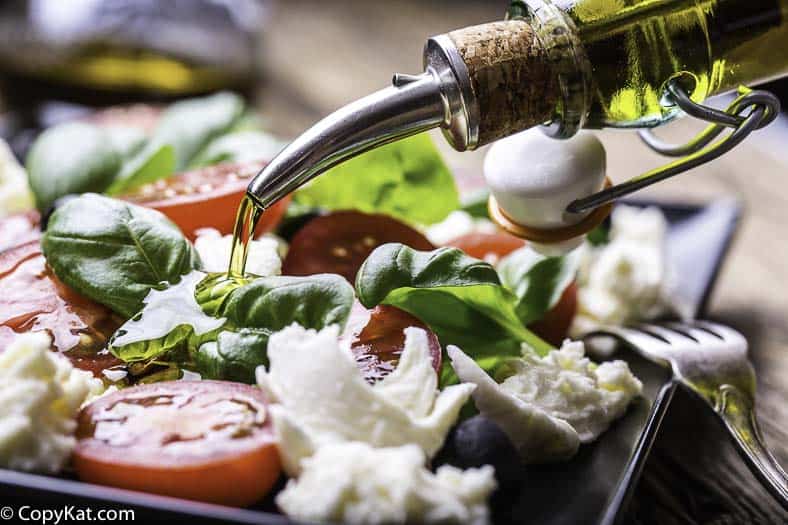 A salad made of fresh tomatoes, mozzarella, basil and olive oil. 