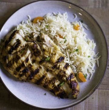 Homemade Chilis Margarita Grilled Chicken breast on a plate with rice pilaf