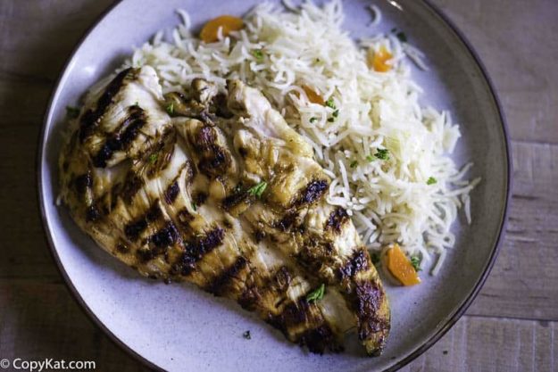 A grilled chicken breast with rice pilaf