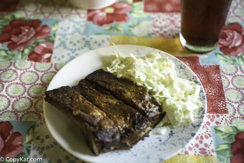 A plate with pork ribs and a sweet and sour coleslaw made with heavy cream.