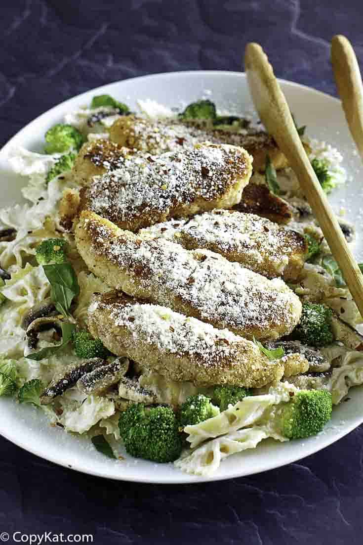 Spaghetti and shredded chicken Parmesan on a plate.