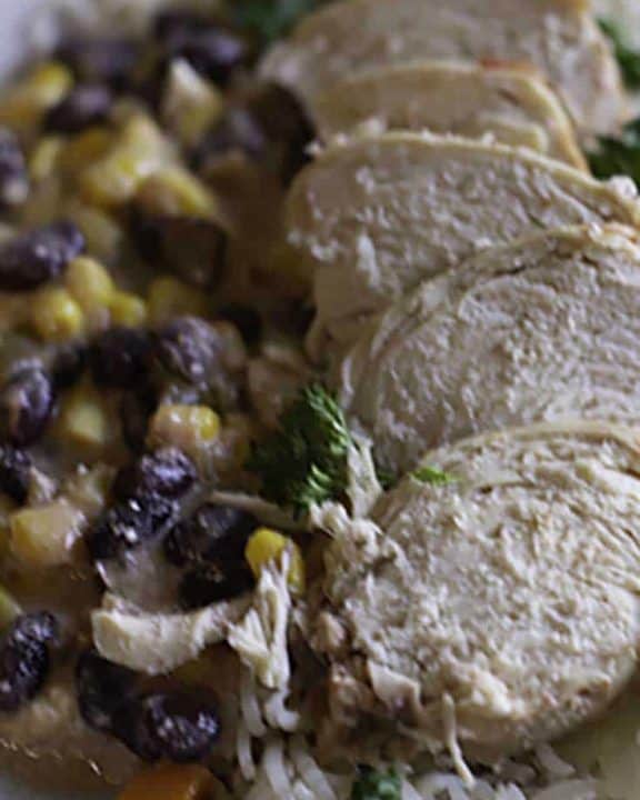 A plate of black beans, corn, and chicken that were prepared in a slow cooker.