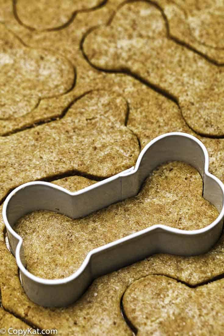 Cutting out dog biscuits with a bone shaped cutter.