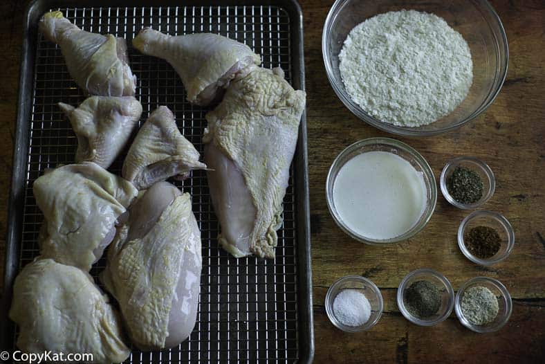 A cut up chicken, potato flakes, and seasonings to make baked chicken 