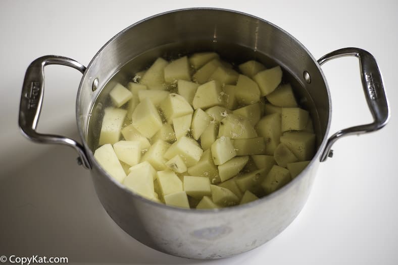 a pot full of cut potatoes and just enough water to cover them