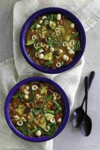 Two bowls of homemade Olive Garden minestrone soup, full of fresh vegetables and pasta