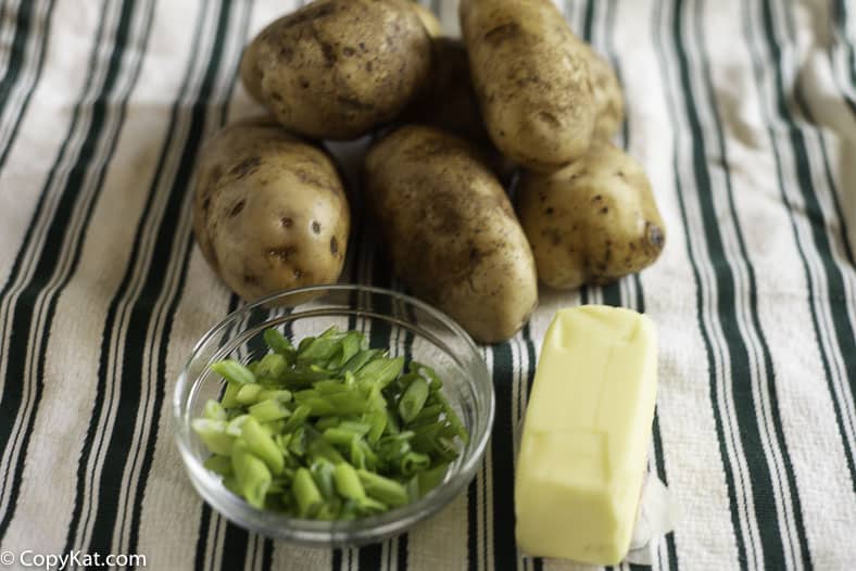 Russet potatoes, butter, and sliced green onions to make champ, one of the best potato recipes around 