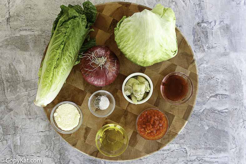Romain lettuce, iceberg lettuce, tomatoes, reddish  onions, and more