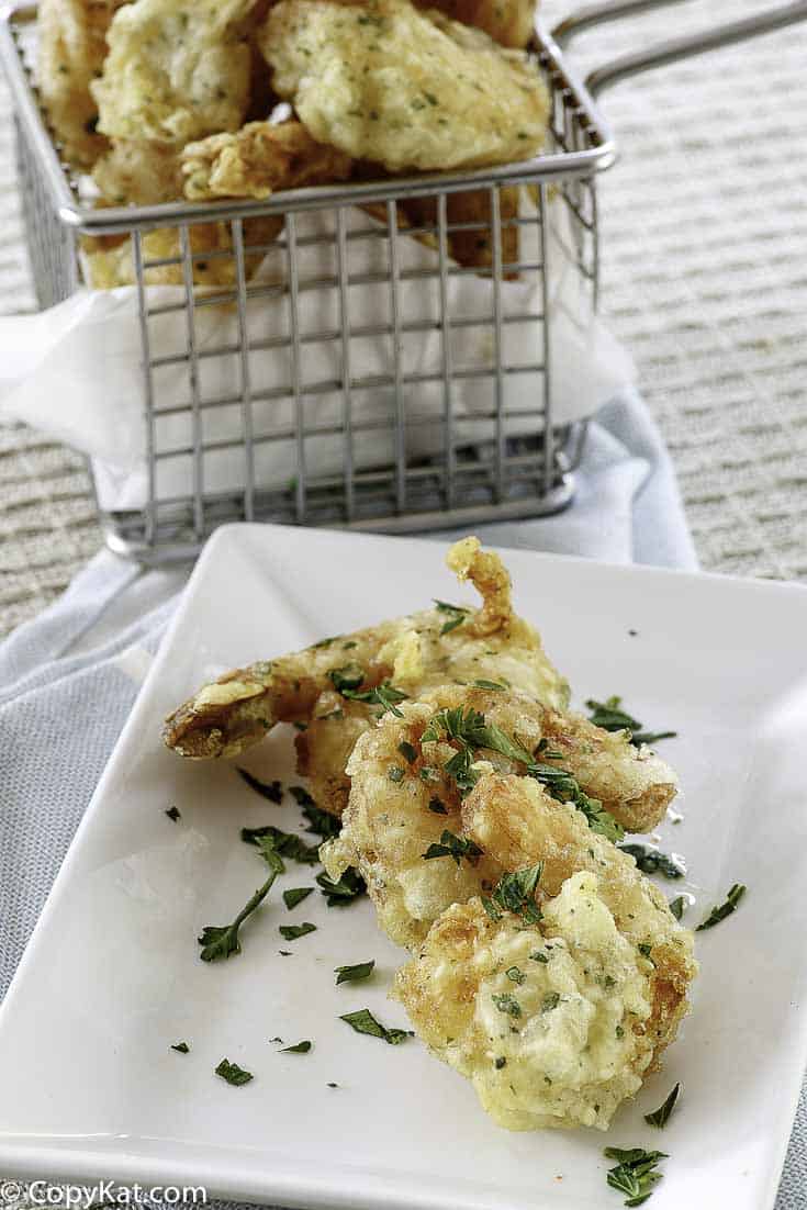 A basket of and a plate of shrimp tempura