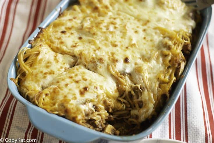 A pan of pasta casserole with lots of cheese on top 