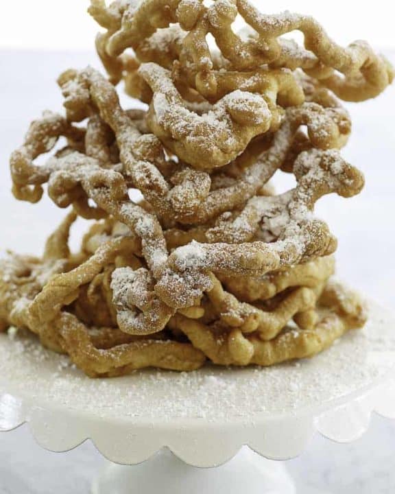 Homemade funnel cakes dusted with powder sugar.