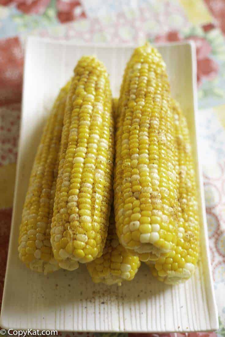 Five ears of homemade Red Lobster Chesapeake Corn on the Cob on a platter.