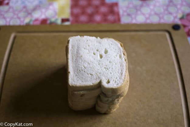 four slices of sandwich bread on a cutting board 