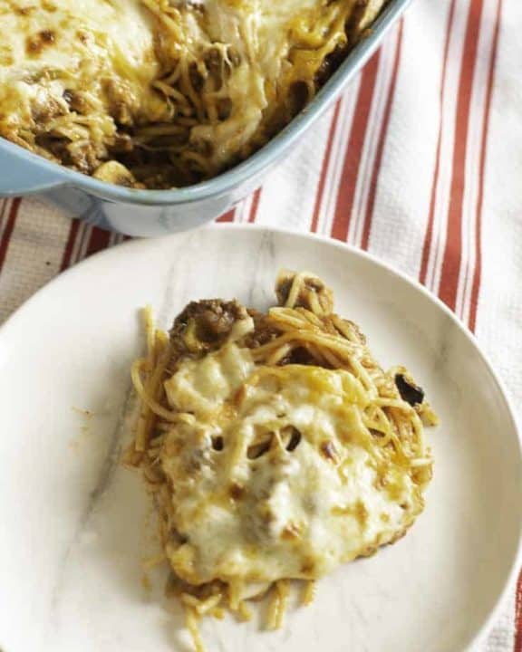 a cheesy spaghetti casserole with onions, peppers, mushrooms, and more.