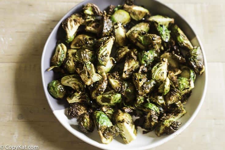 Cooked brussel sprouts with a drizzle of balsamic vinegar