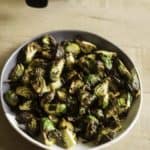 a plate of brussel sprouts with a balsamic vinegar glaze