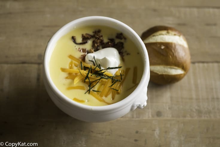 potato soup topped with cheese, bacon, and chives