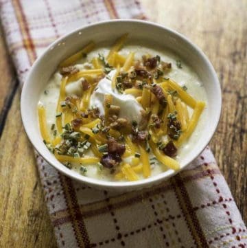 baked potato soup with cheese, sour cream, and scallions